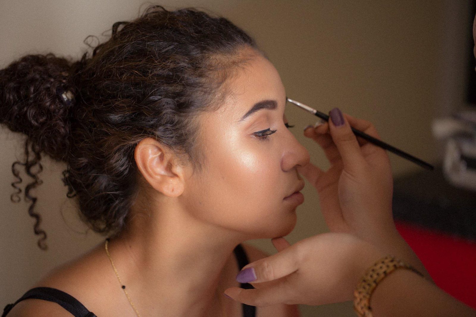 A brow pencil being applied to a client’s brow