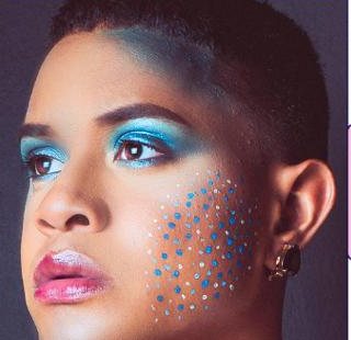 Carnival make-up with blue eyeshadow and blue dots on the cheek